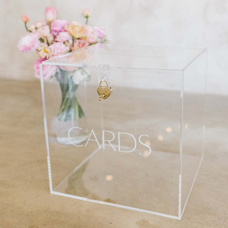 A white acrylic box with a subtle 'cards' embossed on the front box